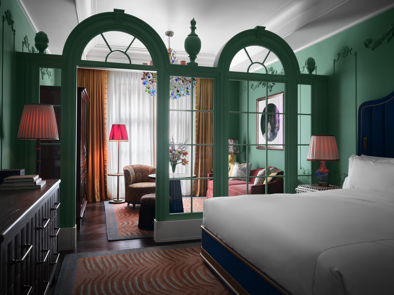 A hotel room in New York City with green arched panelling