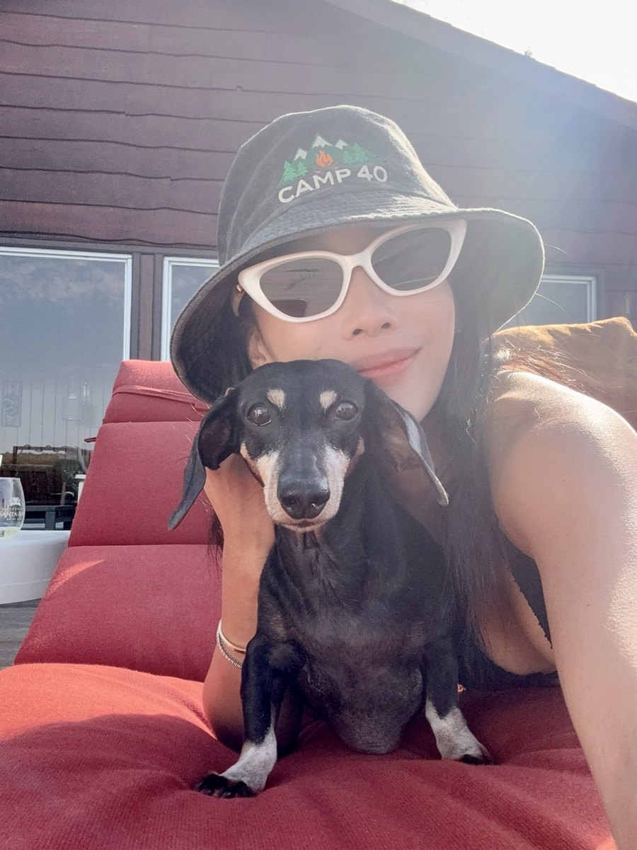 Eva and her miniature dachshund Lady on a sunny cottage deck
